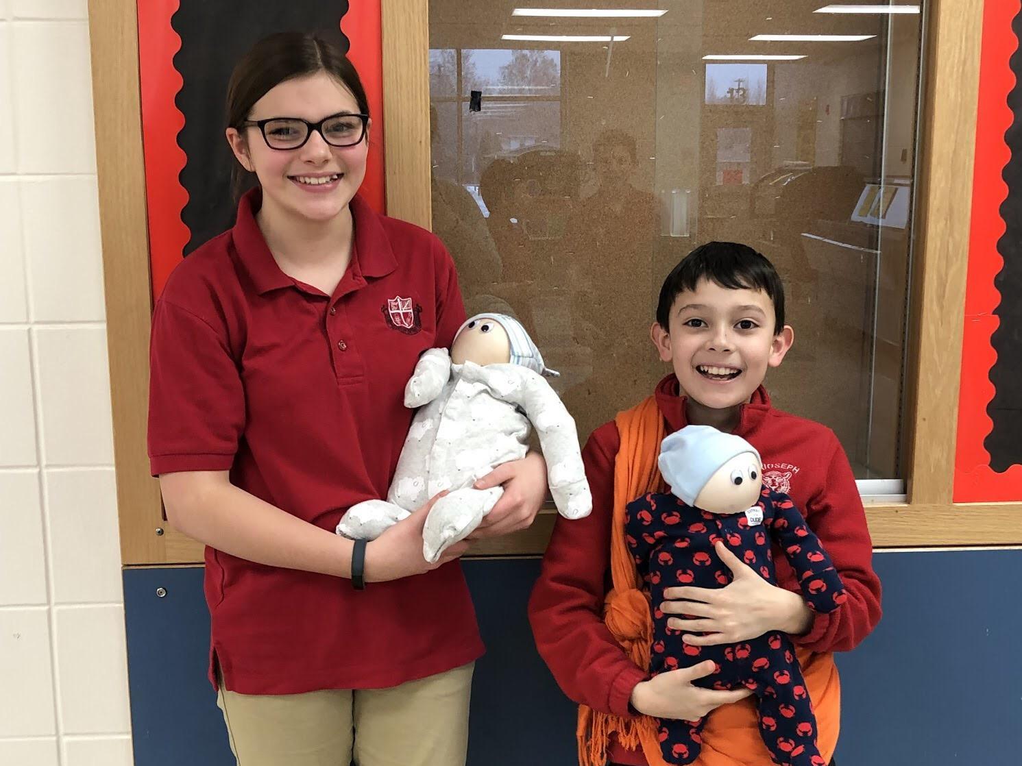 Addison Stevens and Jerome Bastian Ibarguengoitia hold flour babies that were part of the Life Skills quarter class.